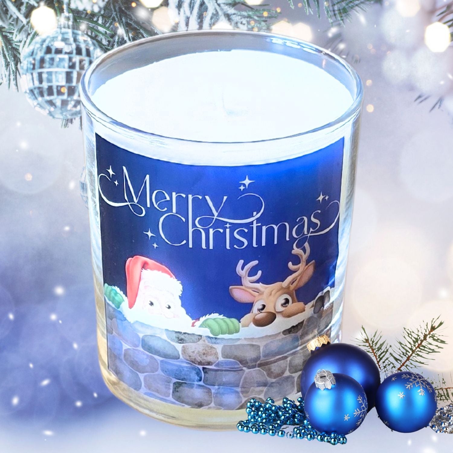 A Christmas scented candles with a charming Merry Christmas design featuring Father Christmas and a reindeer peeping over a wall. The candle is set in a snowy festive setting.