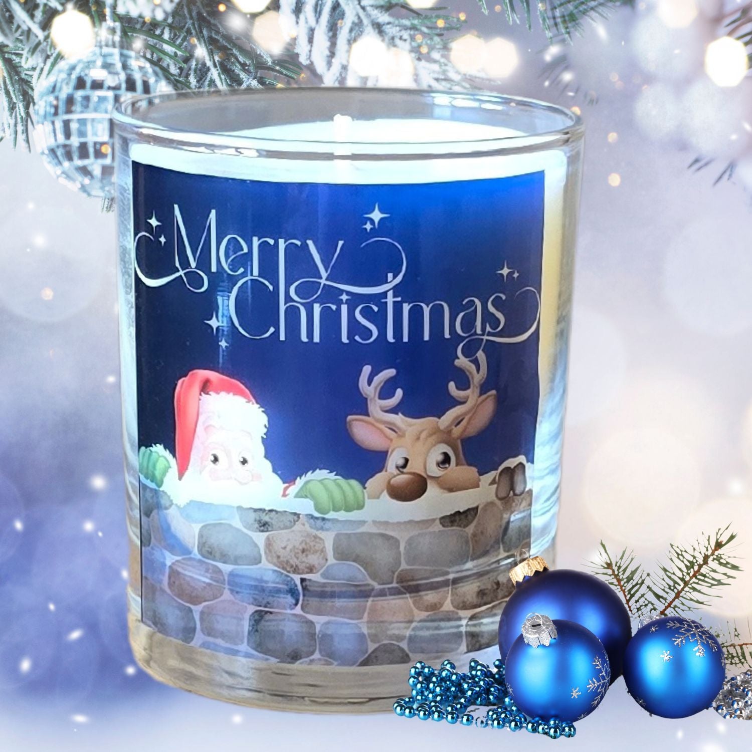 A Christmas scented candles with a charming Merry Christmas design featuring Father Christmas and a reindeer peeping over a wall. The candle is set in a snowy festive setting.