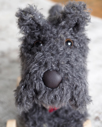 close up of the face of a soft toy scottie dog with grey fur and a cute nose