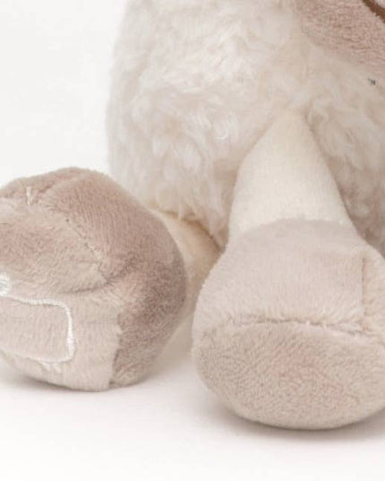 close up of the beige hooves of a sheep soft toy made of very soft white plush fur with beige hooves
