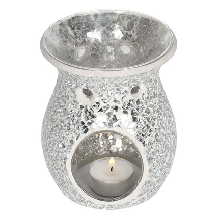 an angled view of the back of a crackle silver wax warmer  showing the glass dish for the wax and with a lit tealight inside