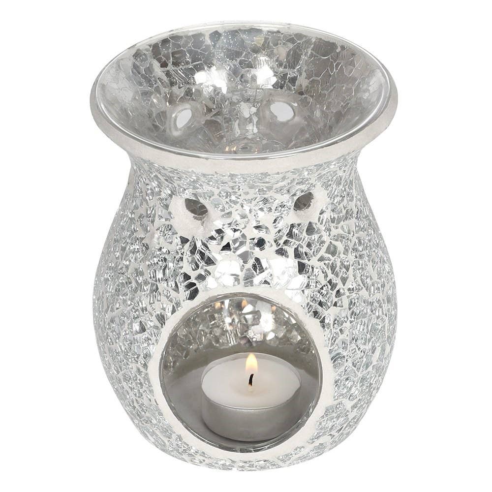 an angled view of the back of a crackle silver wax warmer  showing the glass dish for the wax and with a lit tealight inside