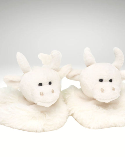 a pair of fluffy cream baby boots featuring cute highland cow heads 