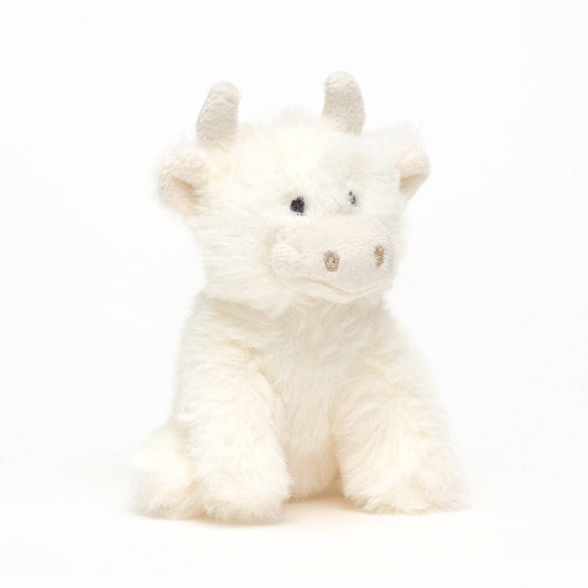a cute cream highland cow with horns made of soft plush fur