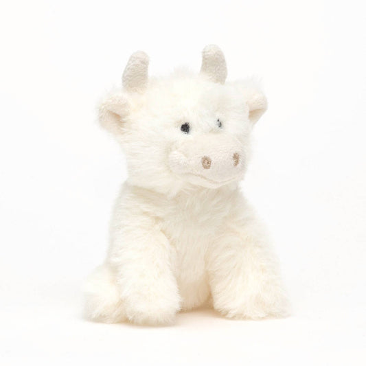 a cute cream highland cow with horns made of soft plush fur
