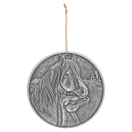  a silver coloured plaque showing a horse with feathers and plaits with its foal