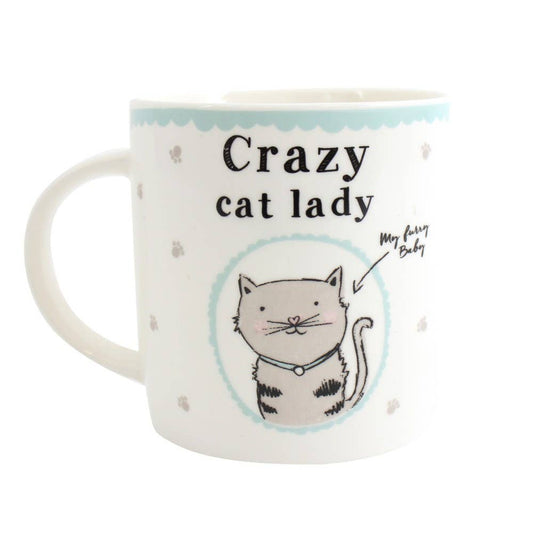 a white ceramic mug with pale blue decoration and silver paws featuring a cute cat with a label my furry baby and with the writing crazy cat lady above
