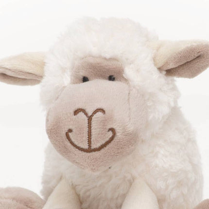 close up of the face of a sheep soft toy made of very soft white plush fur and beige plush face and inner ear in 