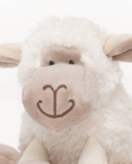 close up of the face of a sheep soft toy made of very soft white plush fur and beige plush face and inner ear in 