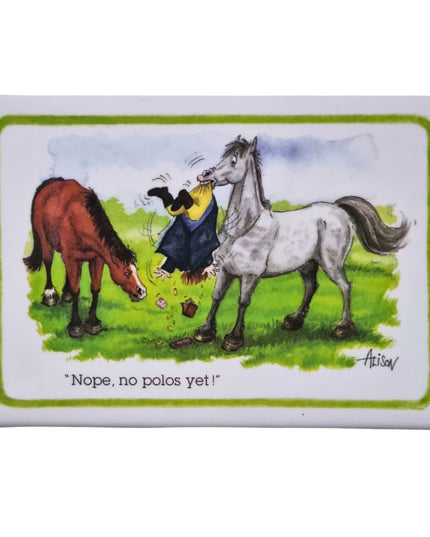 A fridge magnet with a white background showing a cartoon of a horse shaking his owner upside down to see if he has polo mints in his pockets.
