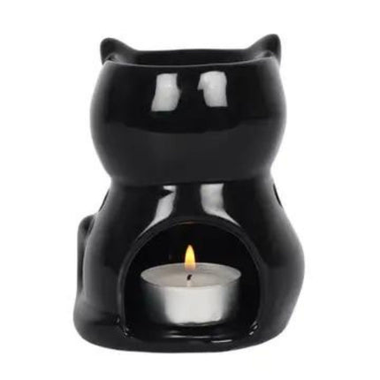 the rear view of a shiny black cat wax warmer showing a burning tealight inside