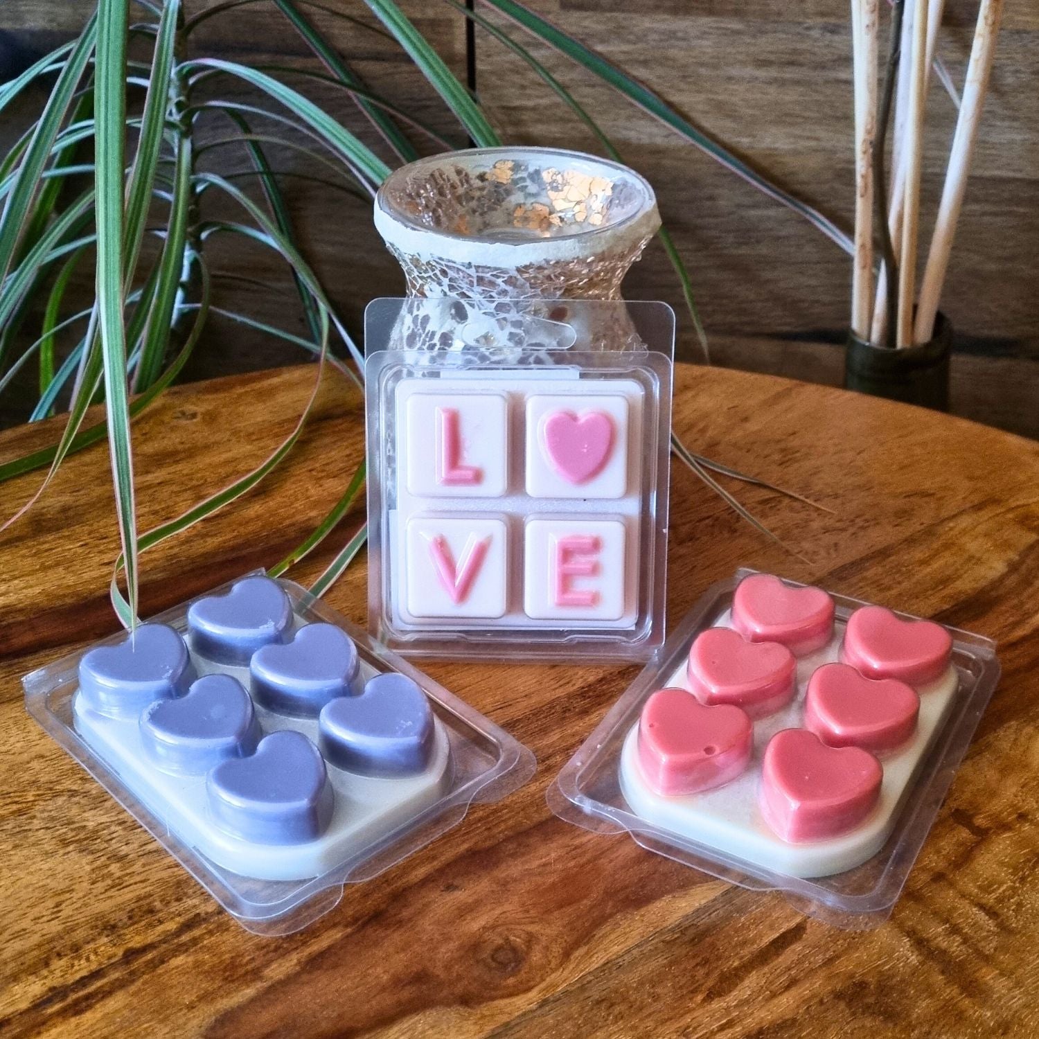 a wax warmer with three wax melt bars in clamshells with love and hearts