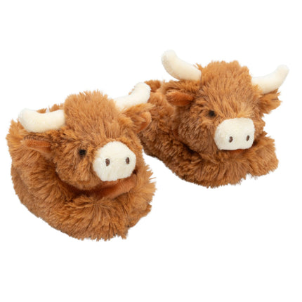 a pair of fluffy brown baby boots featuring cute highland cow heads with cream nose and horns