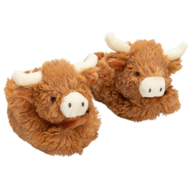 a pair of fluffy brown baby boots featuring cute highland cow heads with cream nose and horns