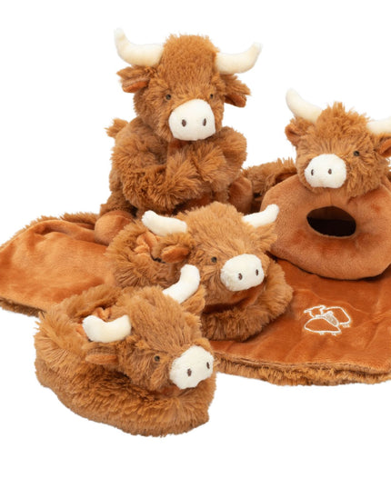 a group of highland cow baby products including a soft toy and comfort blanet, a soft fabric rattle and a pair of fluffy booties.