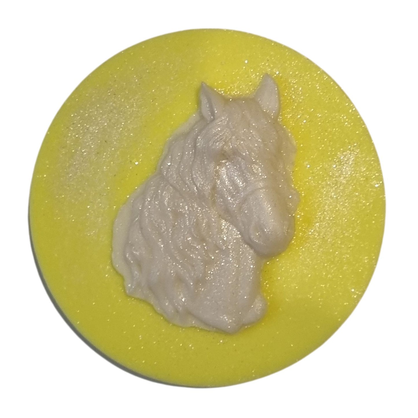 A sunshine yellow disc shaped wax melt with a white wax horses head with a flowing mane and forelock.