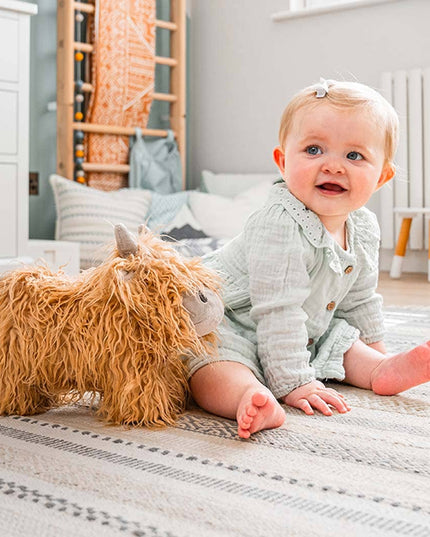 a cute highland cow stuffed toy with golden fur with a baby
