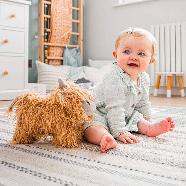 a cute highland cow stuffed toy with golden fur with a baby