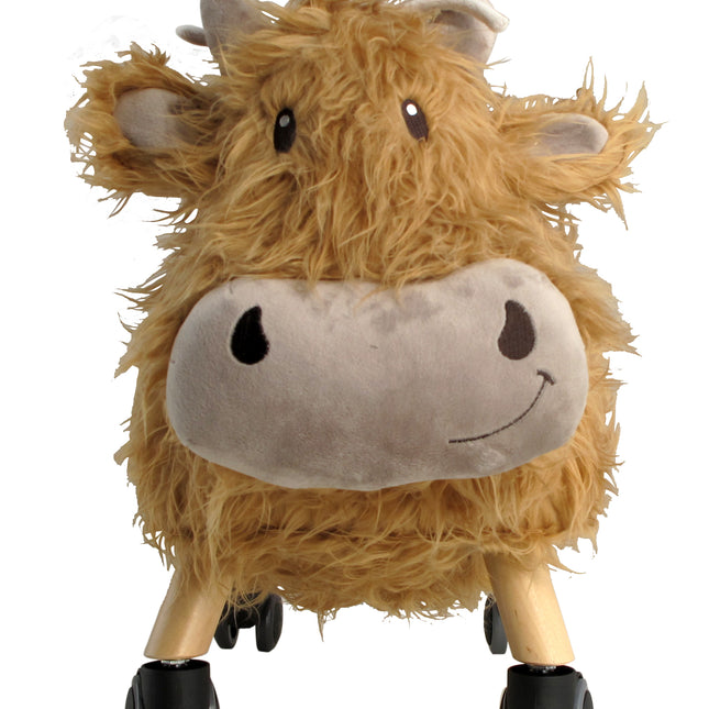 a golden brown highland cow with a large  smiley face