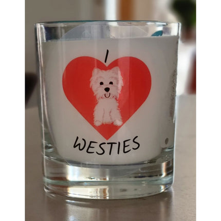 A scented candle in a glass container from Quaver&Lyric, featuring an I â™¥ WESTIES design with a red heart and adorable white West Highland Terrier on the front.