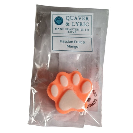a packet containing an orange Paw Shaped Soy Wax Melt  with white pads