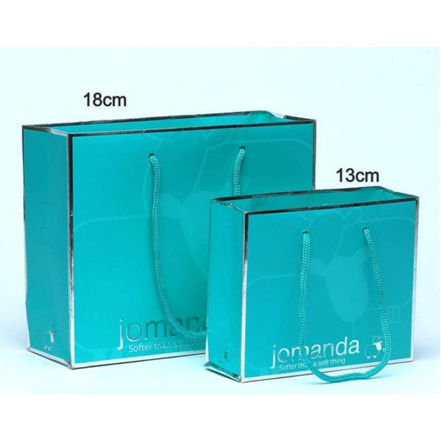 Two turquoise Jomanda Soft Toys & Accessories Gift Bag Small (13cm) bags with rope handles and jomanda printed on the front are side by side—ideal for gifting mini toys or baby rattles.