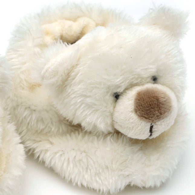 A close-up of Jomanda Soft Toys & Accessories Teddy Bear Slippers For Infantsâ€”cream, soft plush slippers with stitched bear featuresâ€”perfect as a cozy baby shower gift, set against a white background.