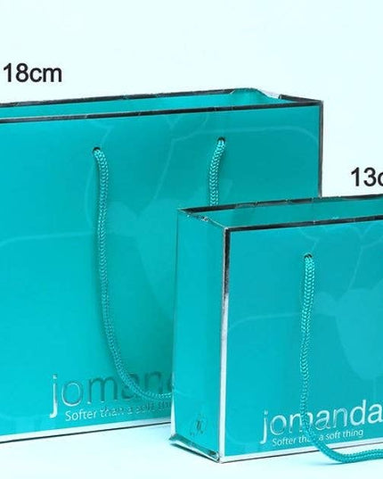 a pair of aqua coloured gift bag with silver jomanda branding with sizes 18cm and 13cm