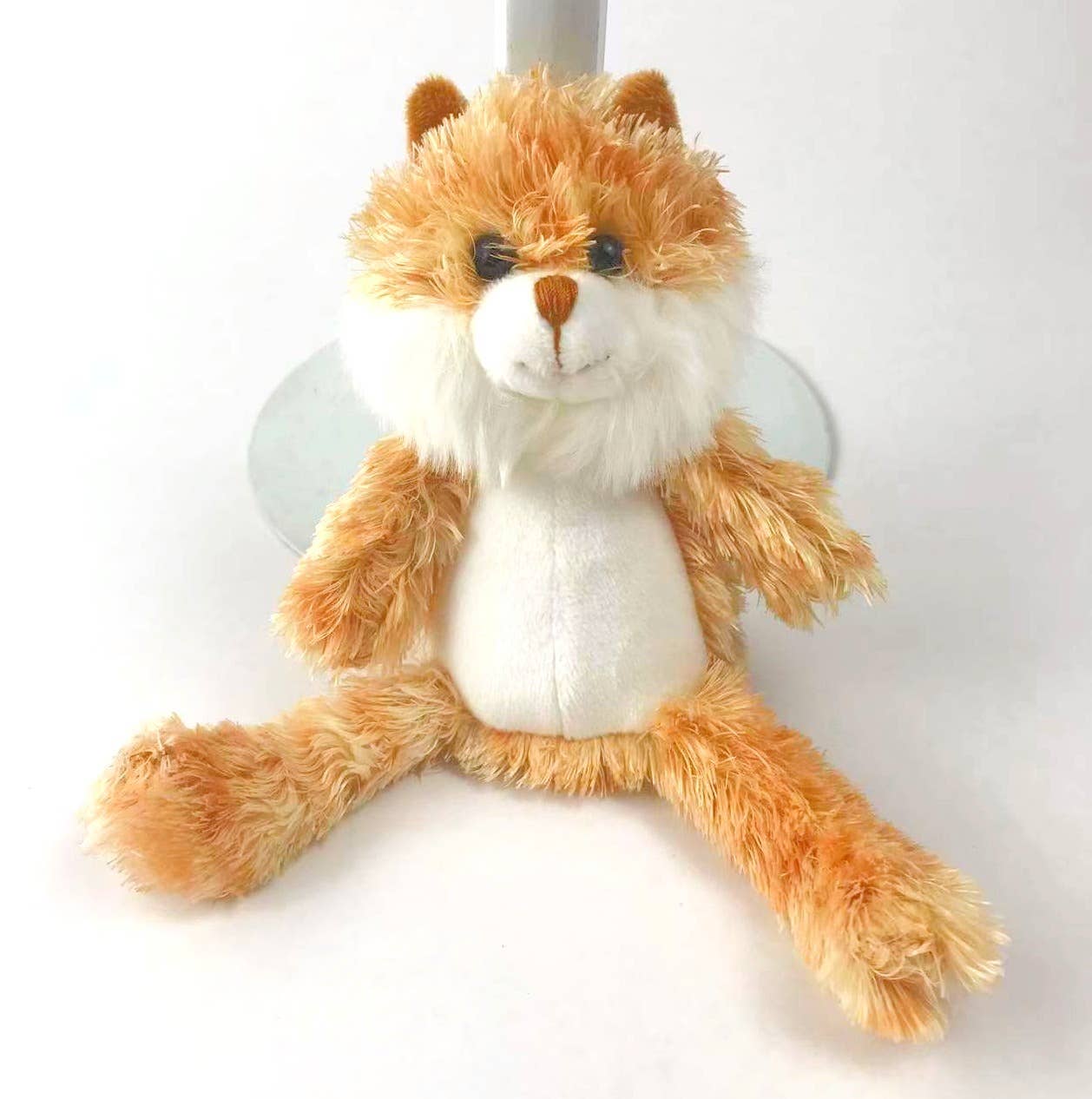 a ginger cat teddy made of orange plush fur and a white tummy and chin