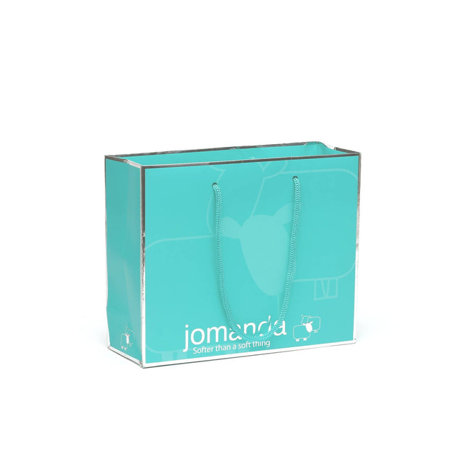an aqua coloured gift bag with silver jomanda branding