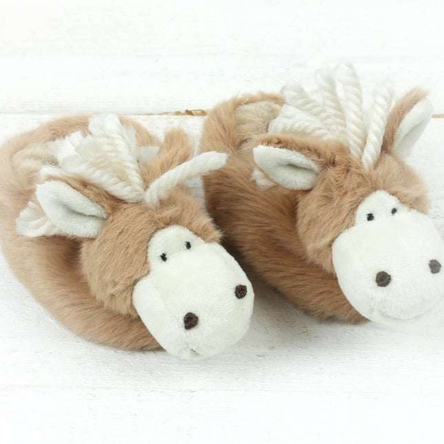 A pair of Jomanda Soft Toys & Accessories Horse Slippers For Infants, designed as light brown and white horses with soft manes, ears, and embroidered details, are displayed on a white wooden surface.