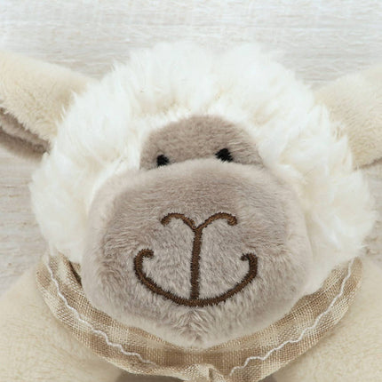 close up of the face of a sheep rattle showing his beige plush face with embroidered muth and eyes