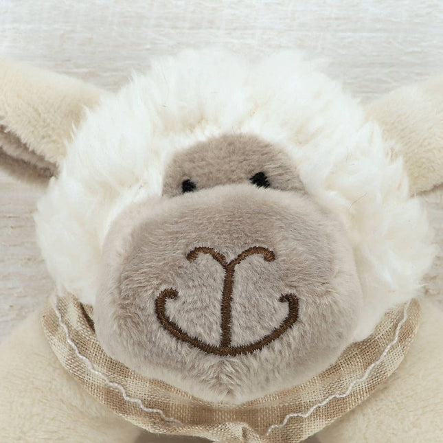 close up of the face of a sheep rattle showing his beige plush face with embroidered muth and eyes