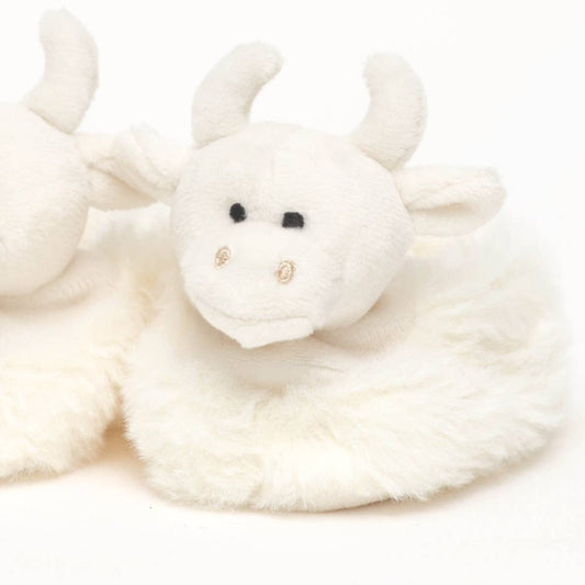 close up view of one of a pair of fluffy cream highland cow baby boots from Jomanda toys