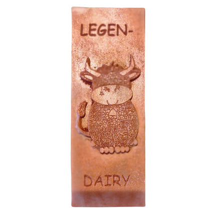 a bronze coloured Wax Melt bar with highland cow and writing legen....dairy