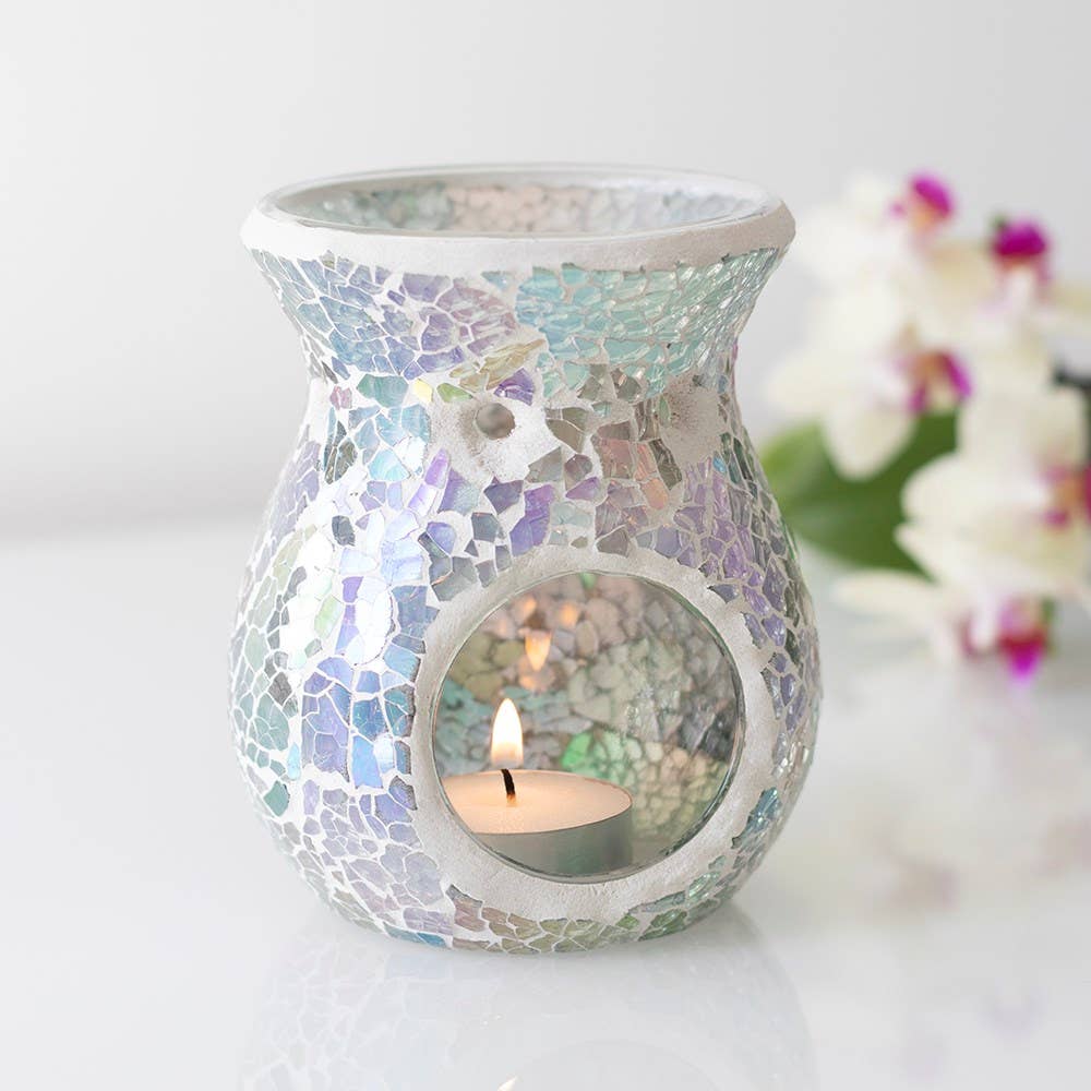 the back view of a small light blue iridescent crackle design oil burner wax warmer with a lit tealight insie