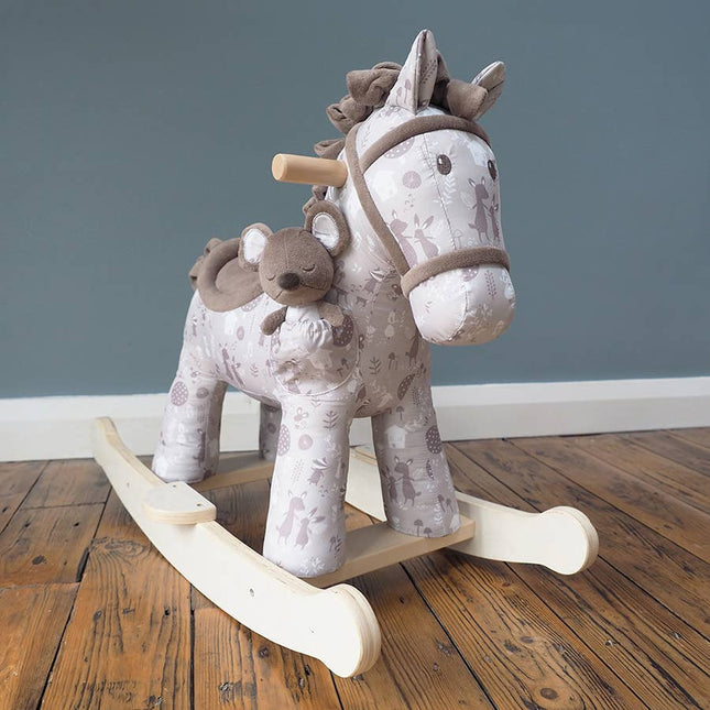 a cute fabric horse with brown bridle, saddle, mane and tail on wooden rockers with a soft toy mouse in a pocket on its shoulder in a room setting