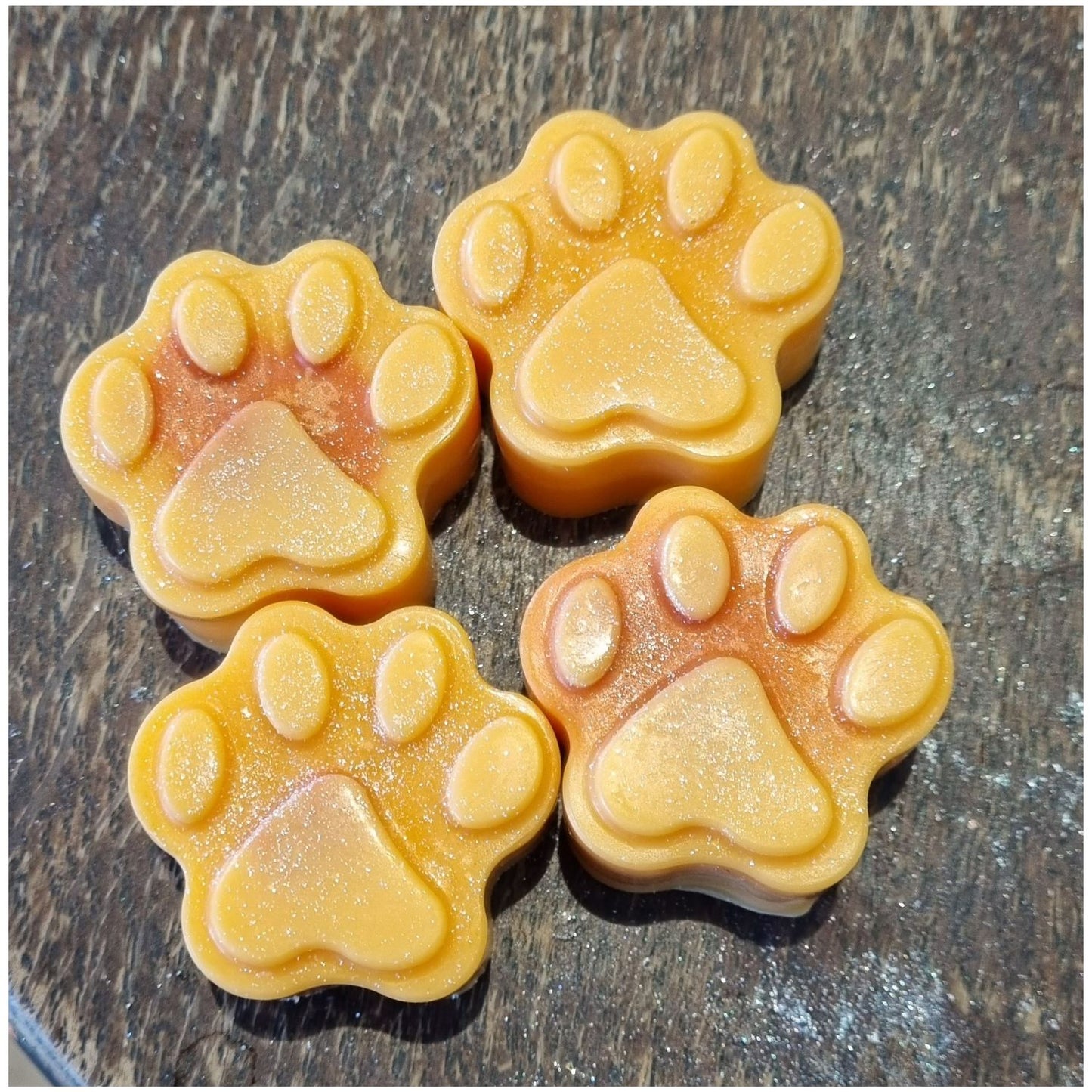 a group of 4 orange coloured paw shaped Soy Wax Melts