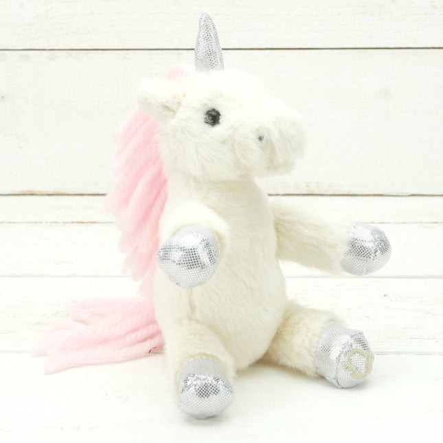 A cream cream plush unicorn with sparkly silver hooves and unicorn horn and a pink mane and tail.