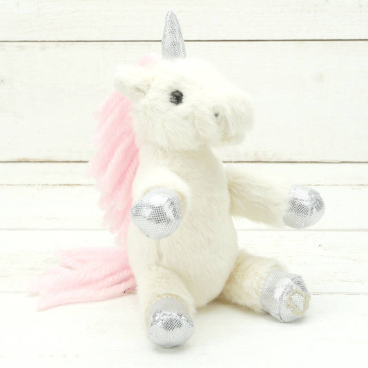 A cream cream plush unicorn with sparkly silver hooves and unicorn horn and a pink mane and tail.