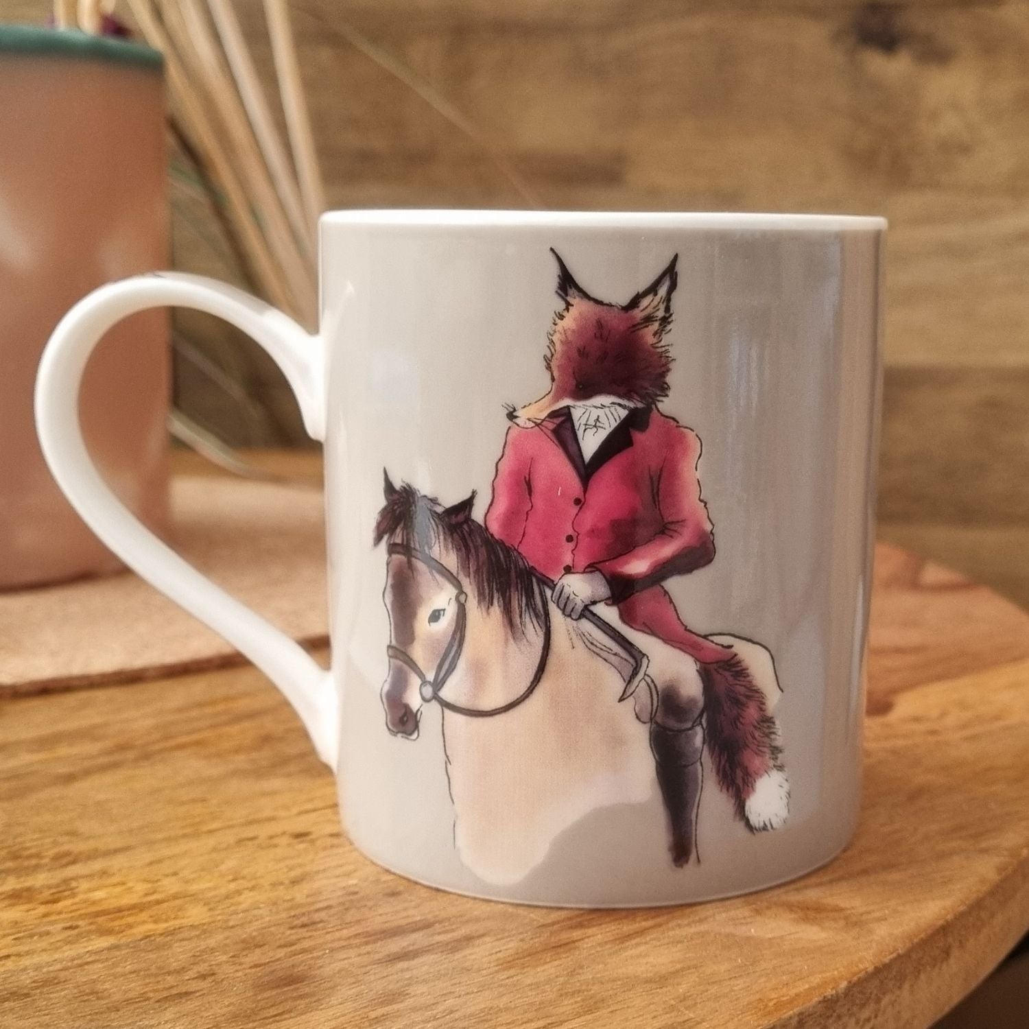 a mug with Mr fox design in traditional hunting dress riding a pony