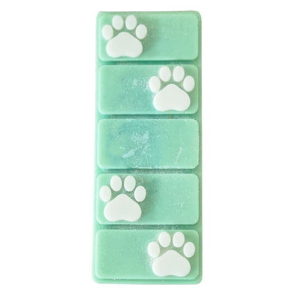 the top view of a green wax melt bar with white paw prints