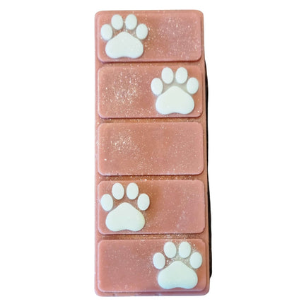 the top view of a brown wax melt bar with white paw prints