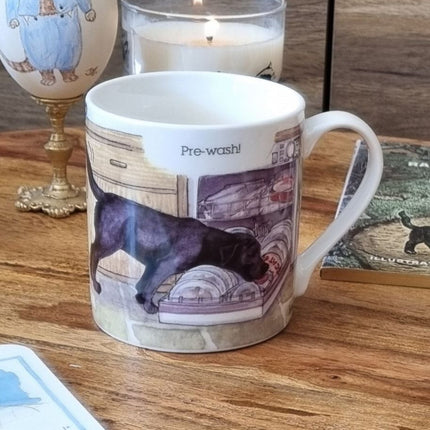 The Dog Mug Alisons Animals Pre-wash Cartoon Gift Boxed by Alisons Animals features a black dog licking dishes in a dishwasher with Pre-wash! above—an ideal animal lover gift.