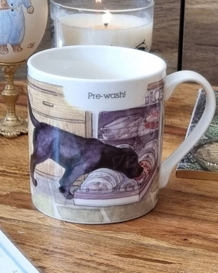 The Dog Mug Alisons Animals Pre-wash Cartoon Gift Boxed by Alisons Animals features a black dog licking dishes in a dishwasher with Pre-wash! above—an ideal animal lover gift.