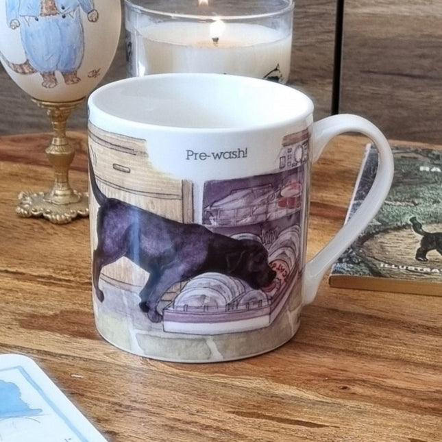 The Dog Mug Alisons Animals Pre-wash Cartoon Gift Boxed by Alisons Animals features a black dog licking dishes in a dishwasher with Pre-wash! above—an ideal animal lover gift.