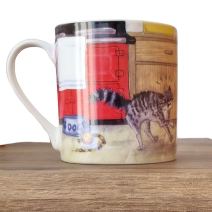 The Alisons Animals Dog Mug features a cartoon of a startled gray tabby cat in a kitchen beside a DOG bowl and toy ball, and comes gift boxed.