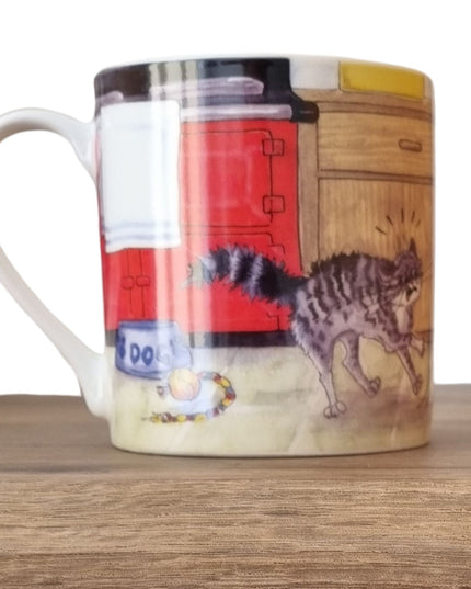 The Alisons Animals Dog Mug features a cartoon of a startled gray tabby cat in a kitchen beside a DOG bowl and toy ball, and comes gift boxed.