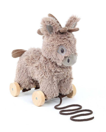 The Pull Along Baby Toy Donkey Norbert by Little Bird Told Me UK features a plush donkey on four wooden wheels, brown face, brown tail, and a black pull stringâ€”perfect for encouraging motor skills in little ones.