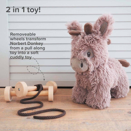 The Pull Along Baby Toy Donkey by Little Bird Told Me UK features removable wooden wheels and a pull string—transform Norbert from an activity pull toy into a soft, cuddly friend. Text: 2 in 1 toy!.